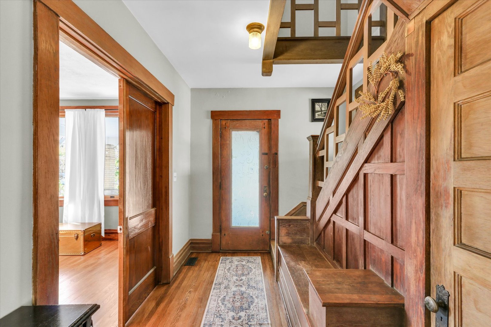1120 West Church Street Champaign, IL 61821 - Photo 9 of 49 a view of an entryway with wooden floor and staircase