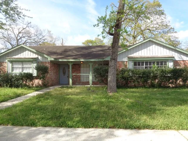a front view of a house with a yard and porch