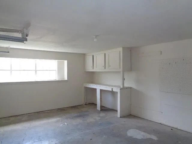 a room with window and white walls