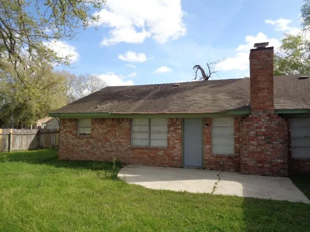 a front view of a house with a garden and plants