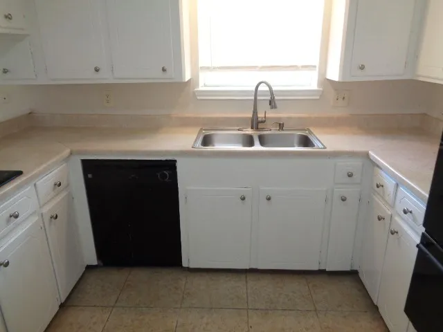 a kitchen with a sink and cabinets