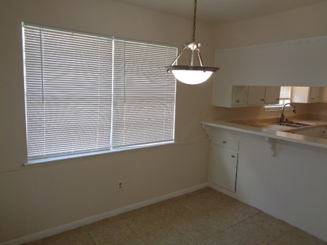 29419 Raestone Street Spring, TX 77386 - Photo 6 of 19 a kitchen with a sink and chandelier