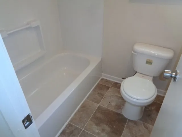 a white toilet sitting next to a white sink