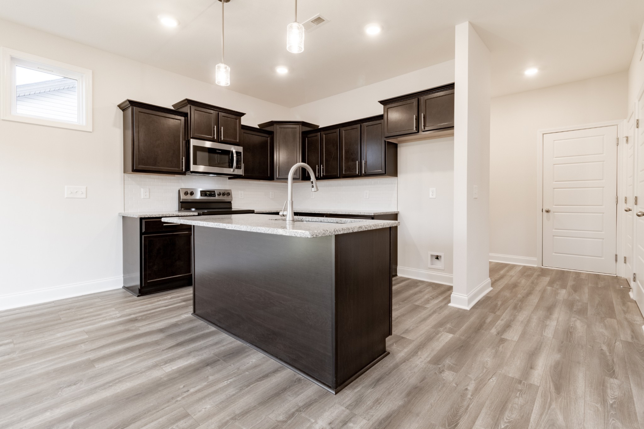 217 Clark Road Clarksville, TN 37042 - Photo 13 of 36 a kitchen with kitchen island stainless steel appliances a sink cabinets and a window