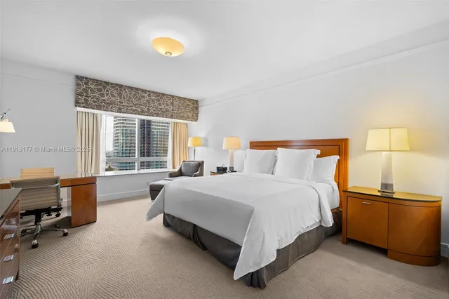 a bedroom with a bed and a flat screen television