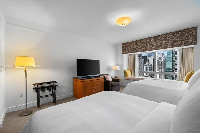 a bedroom with furniture and a flat screen tv