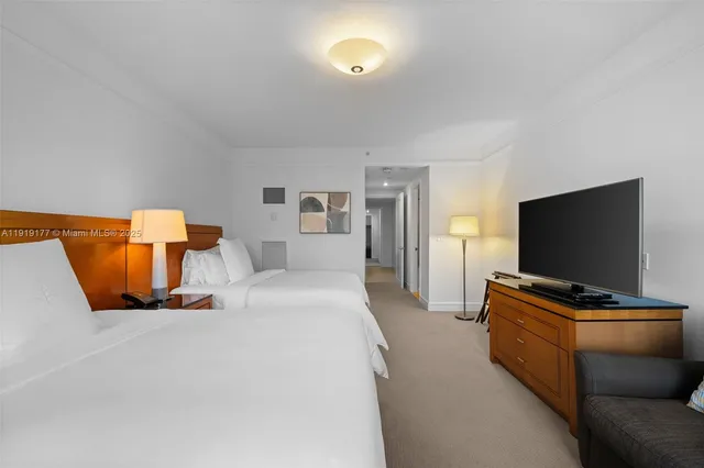 a bedroom with two beds and a couch