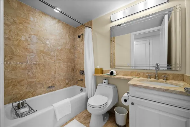 a bathroom with a sink toilet and a mirror