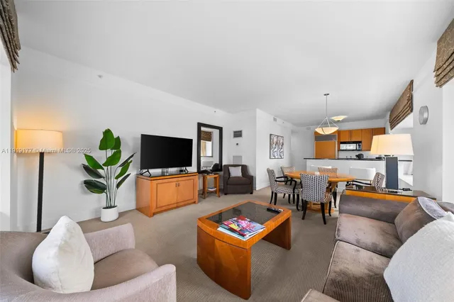 a dining room with furniture a chandelier and window