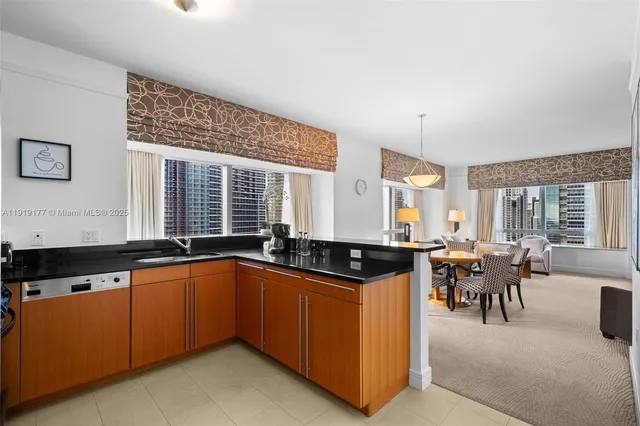 a living room with stainless steel appliances granite countertop furniture and a couch