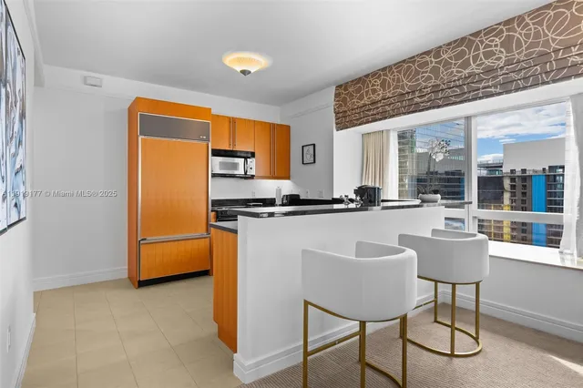 a kitchen with a sink stove and refrigerator