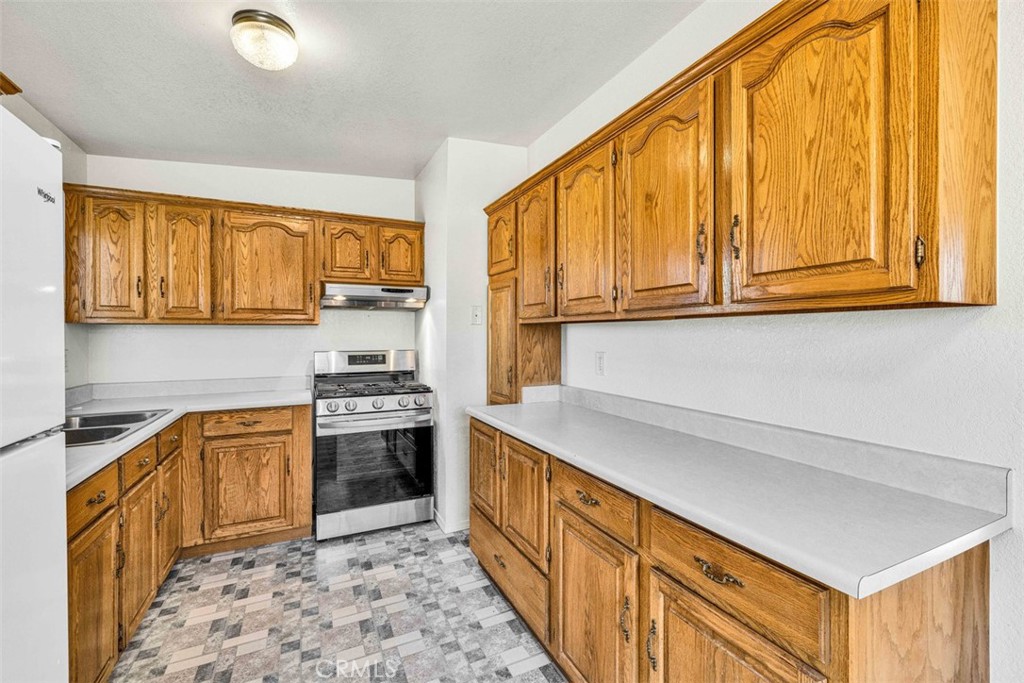 2545 Apache Pass Pioneertown, CA 92268 - Photo 8 of 47 a kitchen with stainless steel appliances granite countertop a stove a sink and a microwave