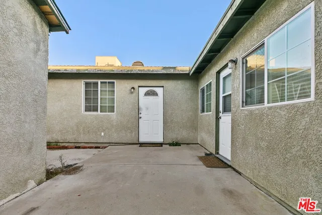 a view of a yard with plants and a fountain