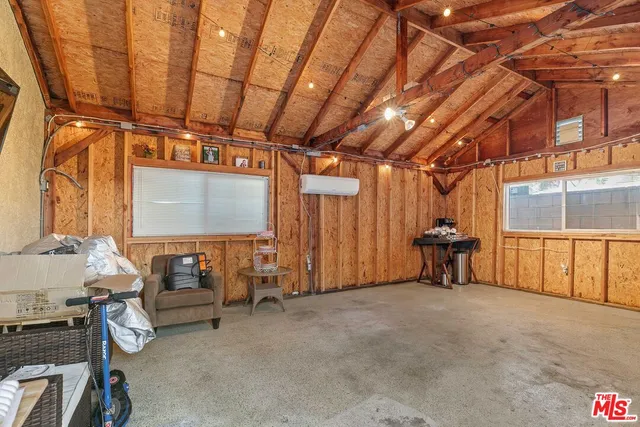 a view of a room with furniture and a window