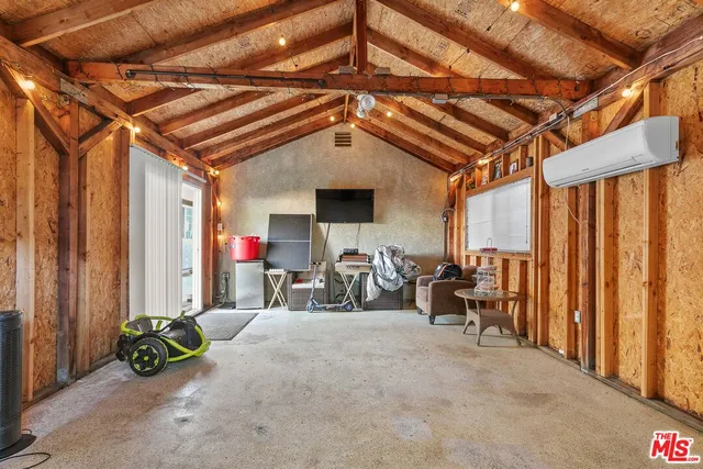 a bedroom with a bed and a television