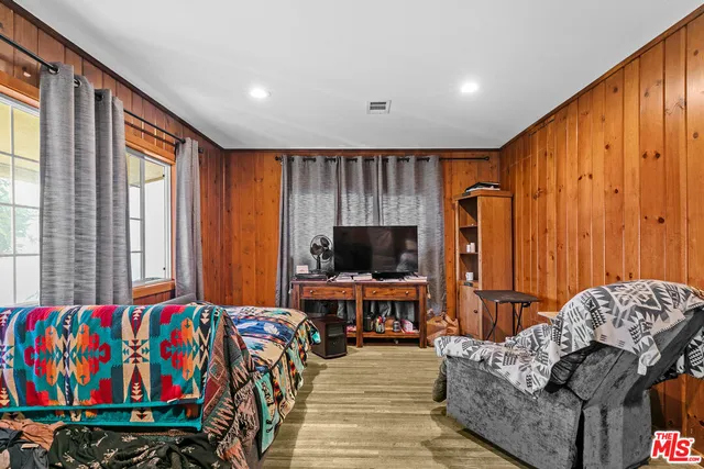a living room with furniture a flat screen tv and a window