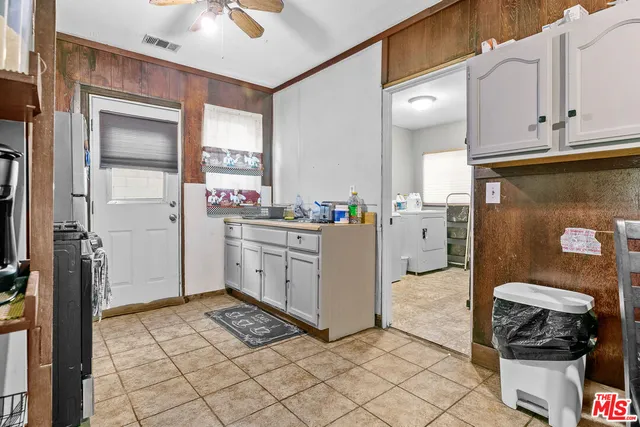 a utility room with cabinets washer and dryer