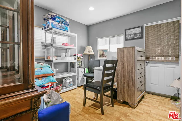 a work room with furniture a rug and a painting on the wall