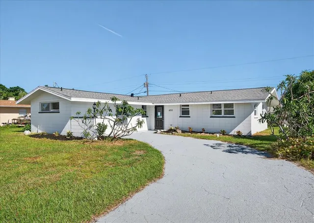 a view of a house with backyard and porch