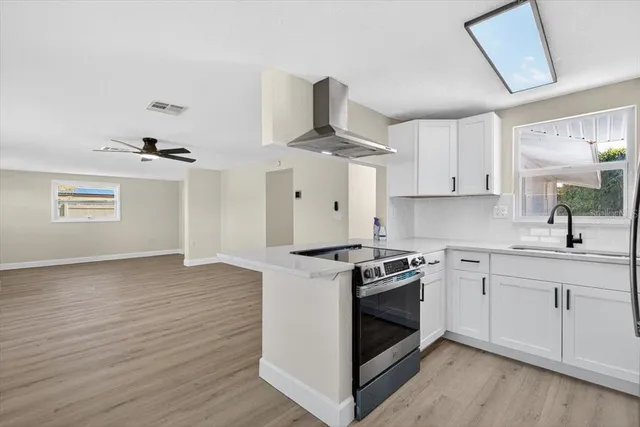 a kitchen with a stove and white cabinets