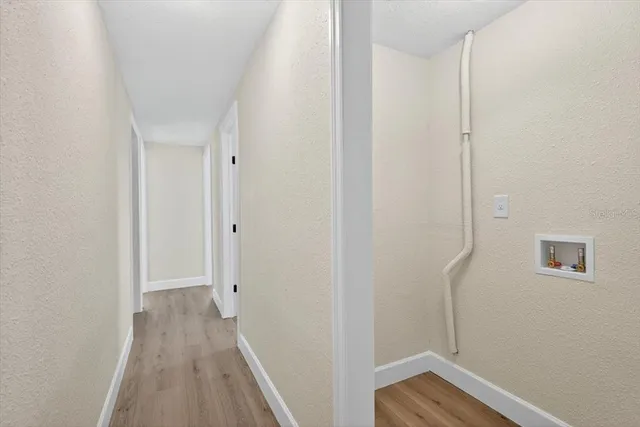 a view of a room with wooden floor