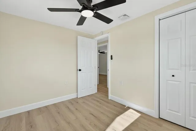 a view of an empty room and wooden floor