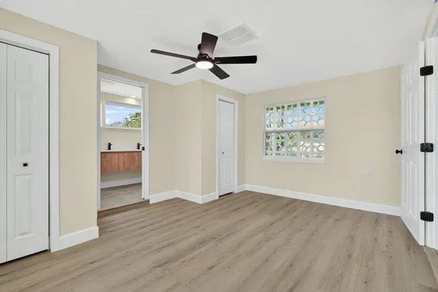 a view of empty room with wooden floor