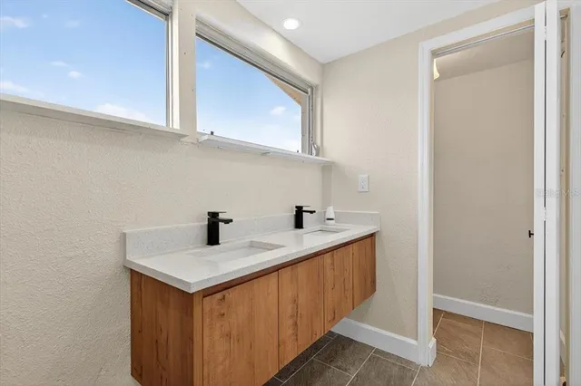 a kitchen with a sink cabinets and a window