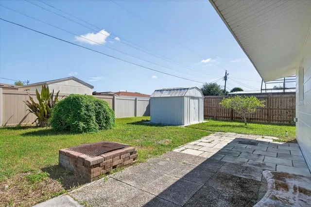 a view of a backyard with plants and a garden