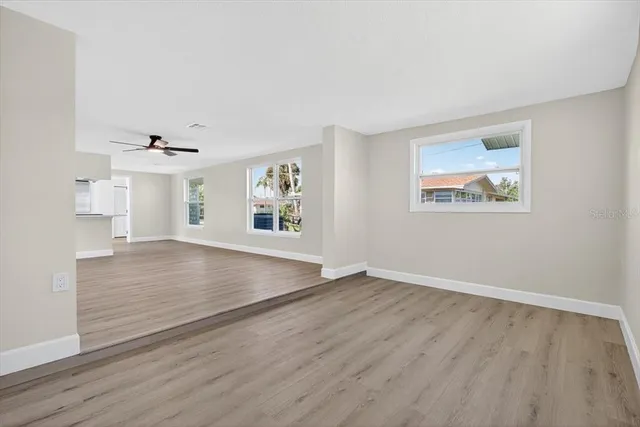 wooden floor in an empty room with a window