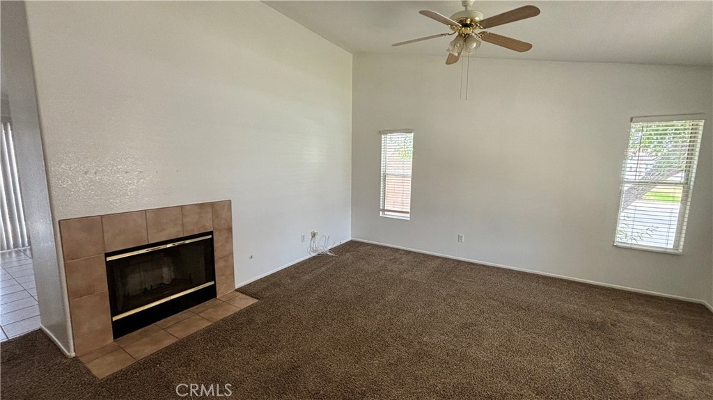 875 South Gilbert Street Hemet, CA 92543 - Photo 2 of 5 an empty room with windows and fireplace