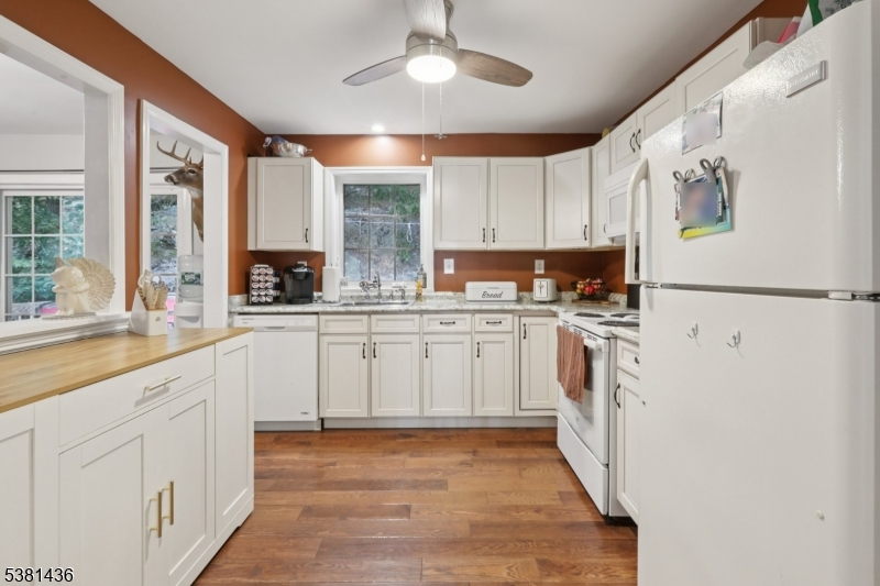 23 Fordham Trail Hopatcong, NJ 07843 - Photo 14 of 31 a kitchen with white cabinets and white appliances