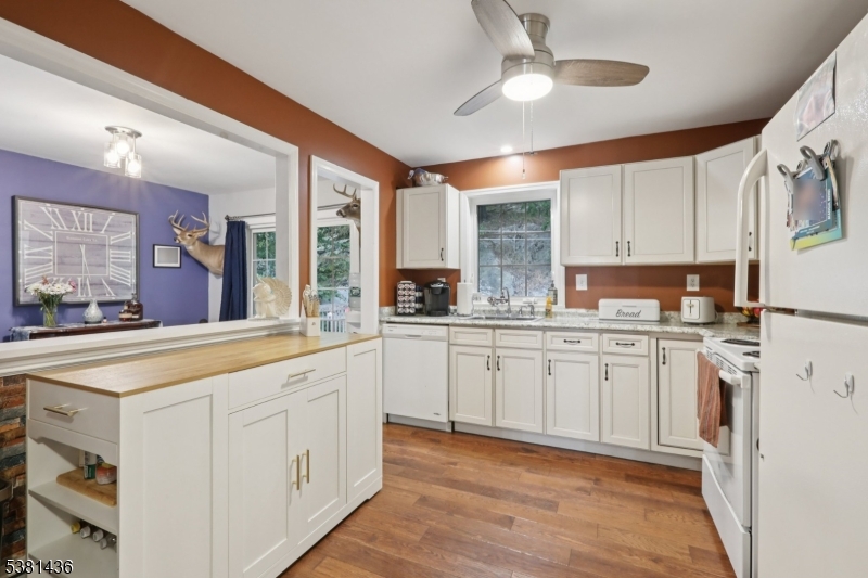 23 Fordham Trail Hopatcong, NJ 07843 - Photo 15 of 31 a kitchen with granite countertop white cabinets white stainless steel appliances with a sink and dishwasher