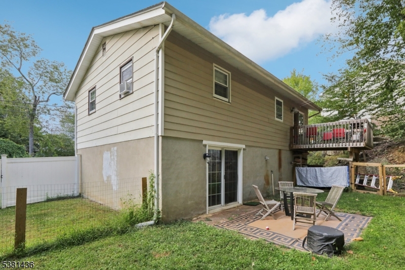 23 Fordham Trail Hopatcong, NJ 07843 - Photo 28 of 31 a chairs and a table in a backyard
