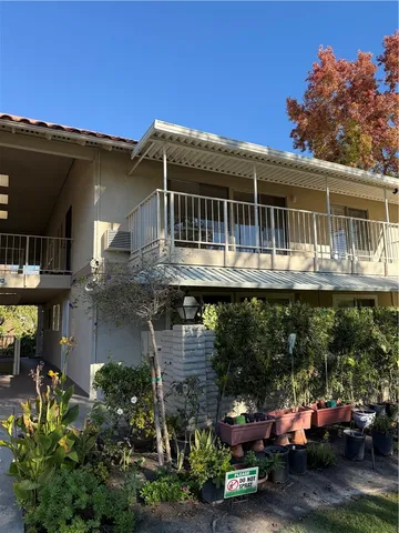 a front view of a house with a garden and sitting area