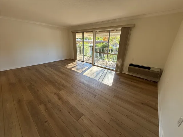 a view of an empty room and wooden floor