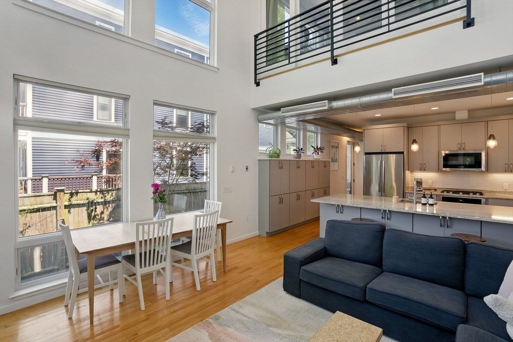 151 Sherman Street Cambridge, MA 02140 - Photo 17 of 35 a living room with furniture wooden floor and kitchen view