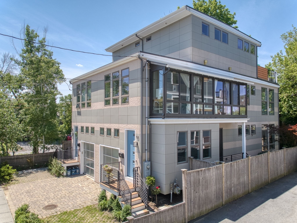 151 Sherman Street Cambridge, MA 02140 - Photo 2 of 35 a front view of a house with a yard