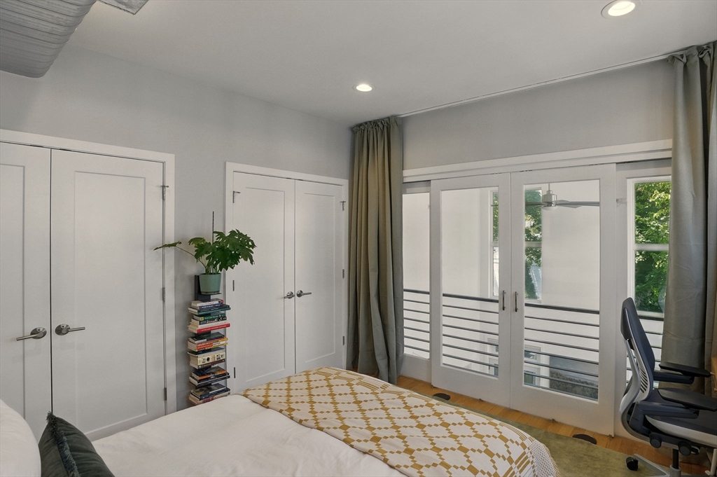 151 Sherman Street Cambridge, MA 02140 - Photo 28 of 35 a bedroom with a bed and a potted plant