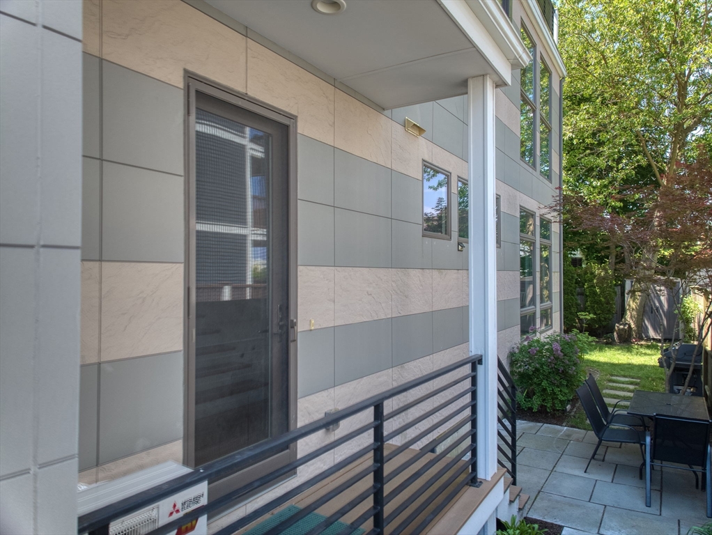 151 Sherman Street Cambridge, MA 02140 - Photo 7 of 35 a view of a porch with a bench