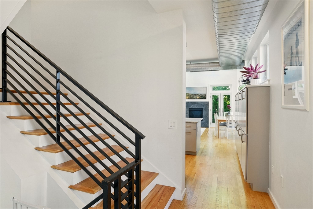 151 Sherman Street Cambridge, MA 02140 - Photo 9 of 35 a view of entryway and hall with wooden floor