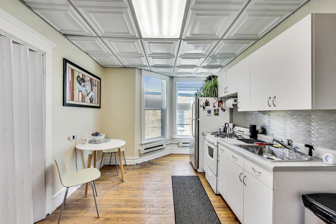25 Webster Avenue Highwood, IL 60040 - Photo 11 of 25 a kitchen with stainless steel appliances a white stove top oven and a refrigerator