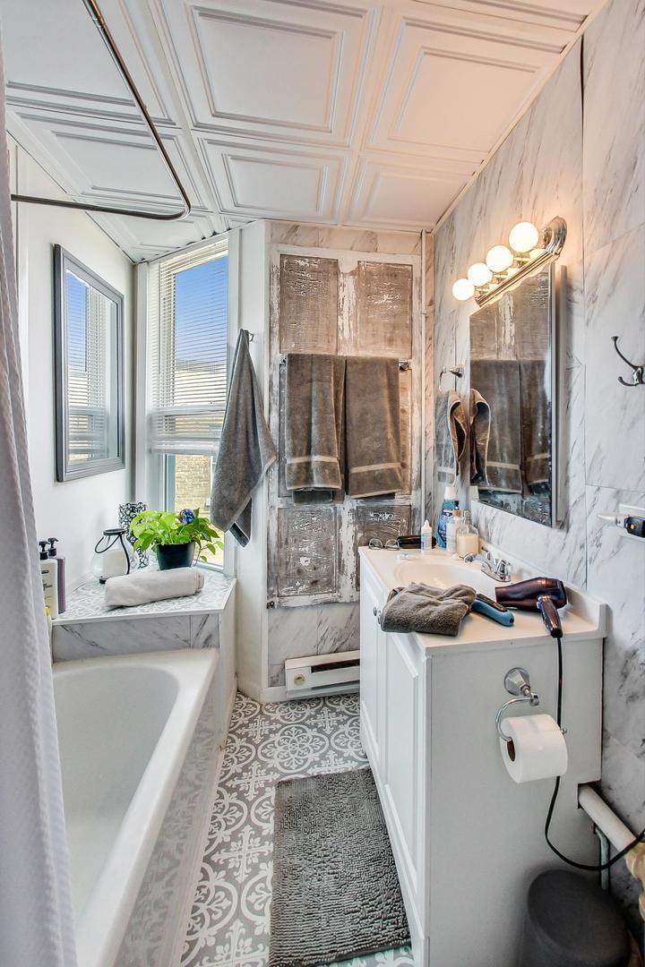 25 Webster Avenue Highwood, IL 60040 - Photo 12 of 25 a bathroom with a granite countertop tub sink and mirror