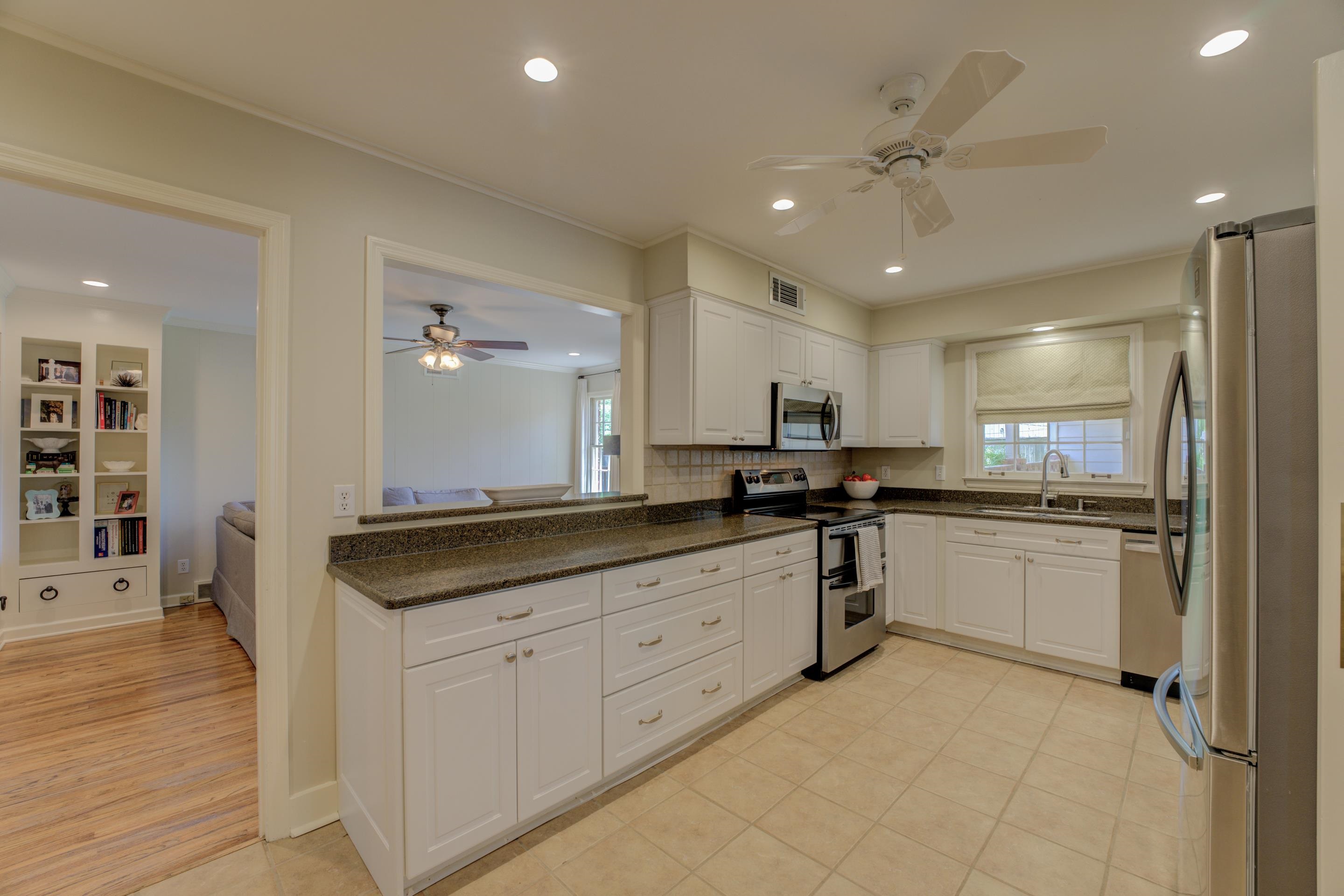 5507 Barfield Road Memphis, TN 38120 - Photo 6 of 31 a kitchen with granite countertop a sink and white cabinets