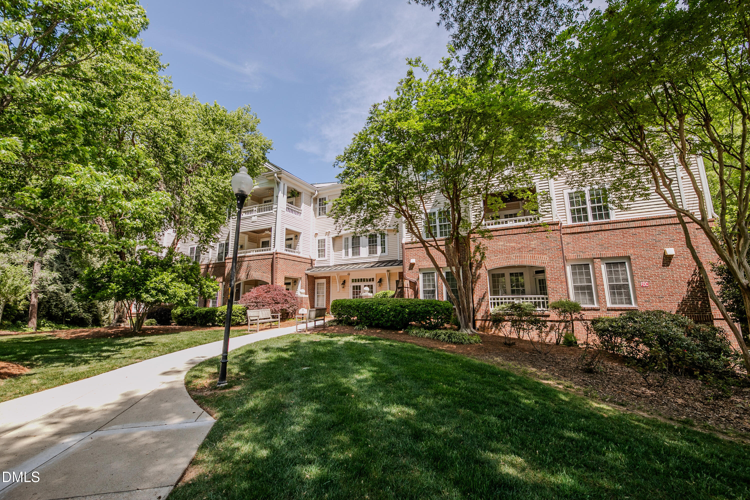 116 Northbrook Drive, Unit 305 Raleigh, NC 27609 - Photo 15 of 43 a front view of a house with a yard and trees