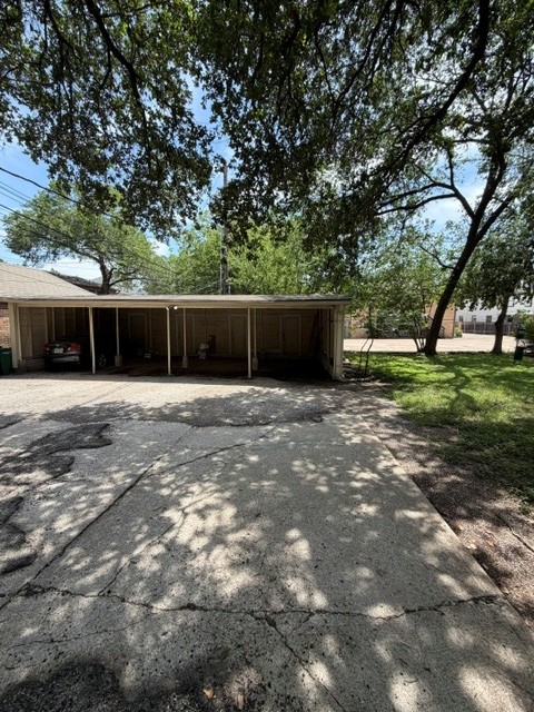1703 Summit View Place, Unit A Austin, TX 78703 - Photo 13 of 13 A spacious carport offers convenient sheltered parking alongside a verdant yard. Includes storage.