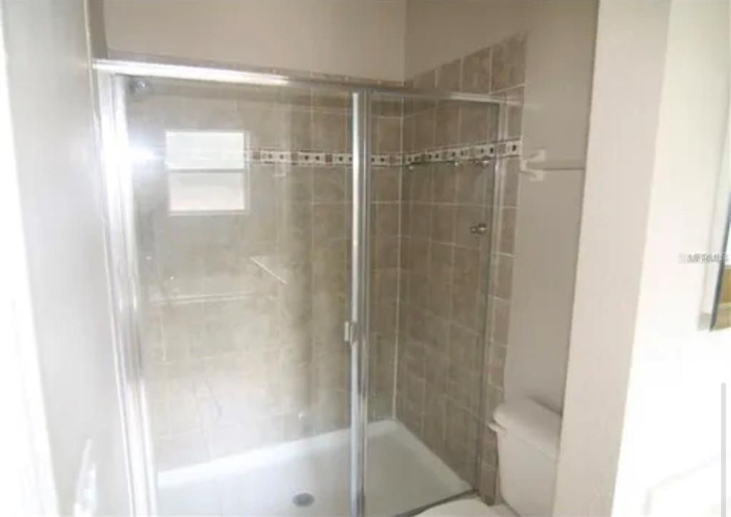 1518 Tally Circle Oviedo, FL 32765 - Photo 11 of 15 a bathroom with a glass shower door