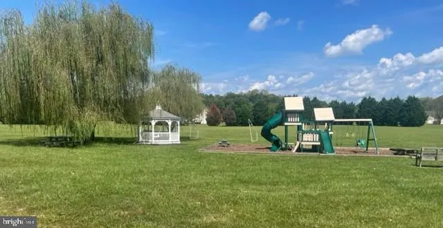 a view of a park with swings and slides
