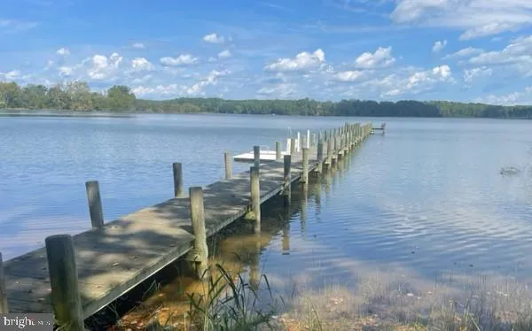 a view of a lake with a table and chairs