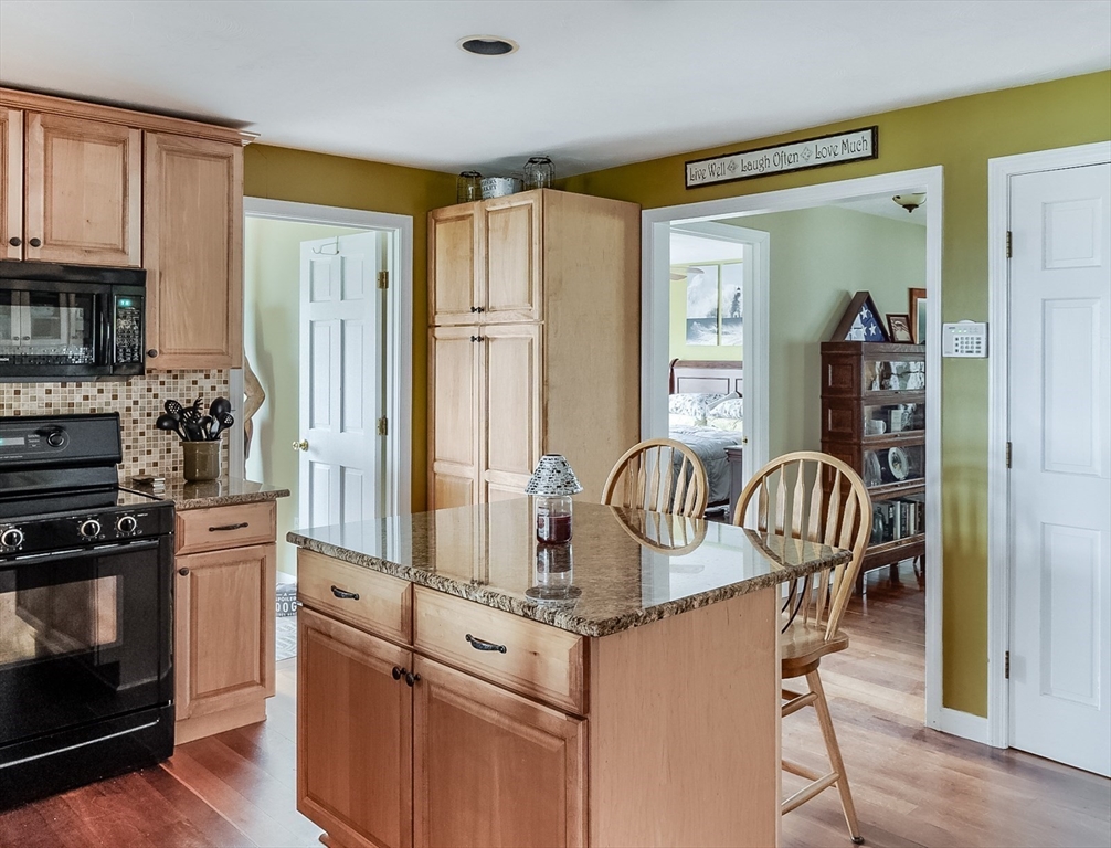 60 Emerald Road Rutland, MA 01543 - Photo 11 of 42 a kitchen with granite countertop a refrigerator and a stove top oven